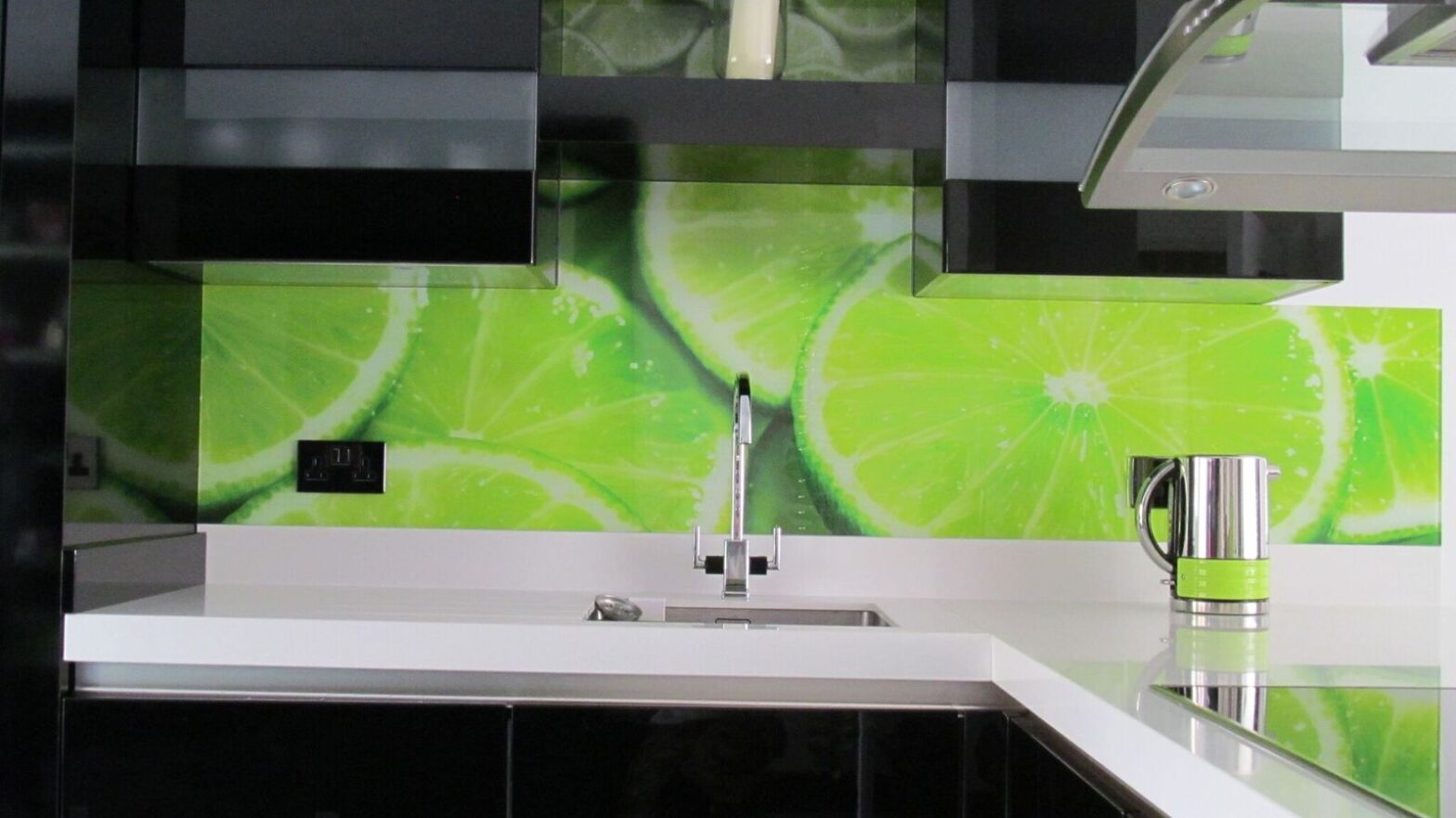 A glass kitchen splashback with a large lime print