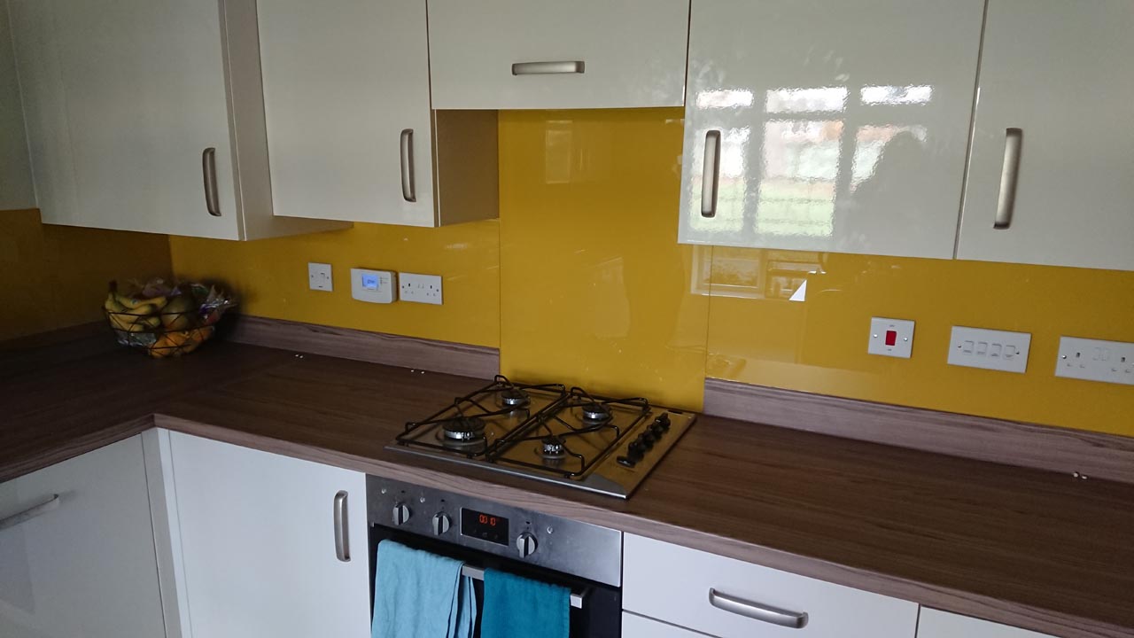 Yellow kitchen splashback with white cupboards