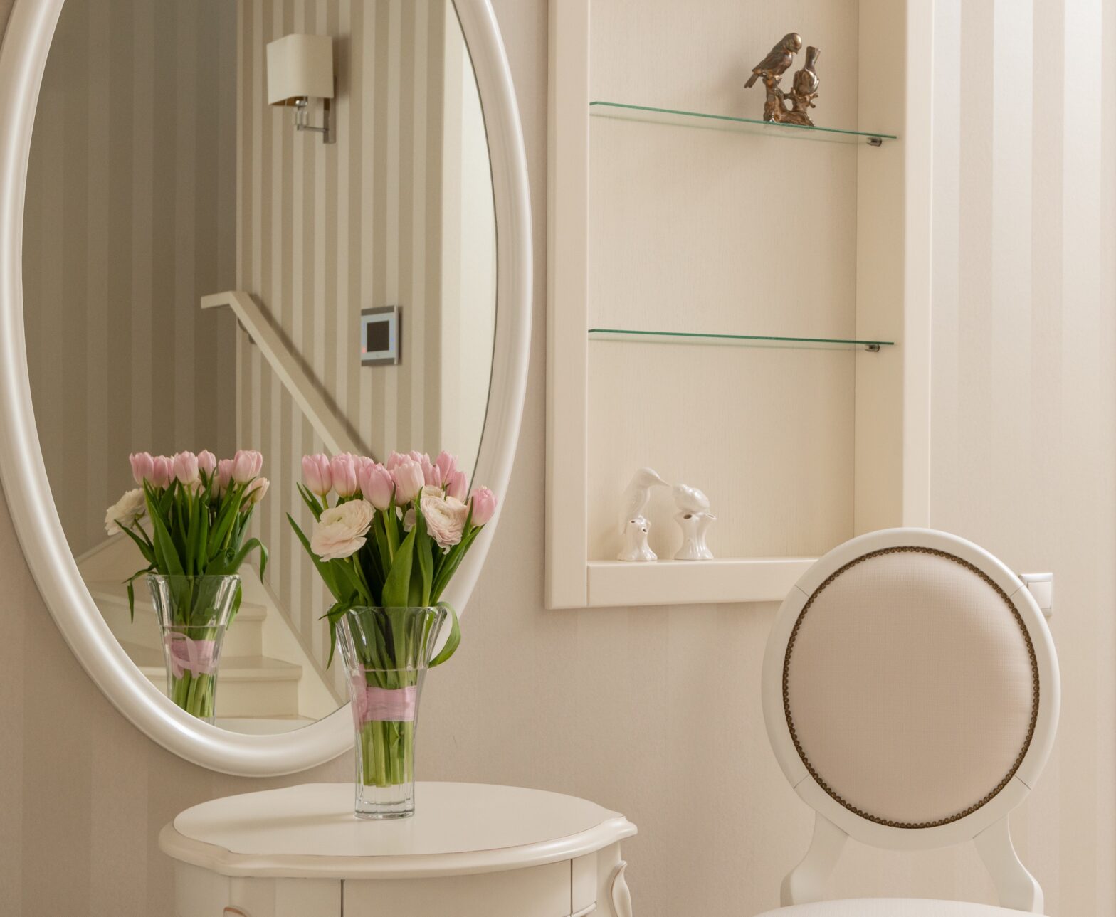 White room with glass shelves set into room.